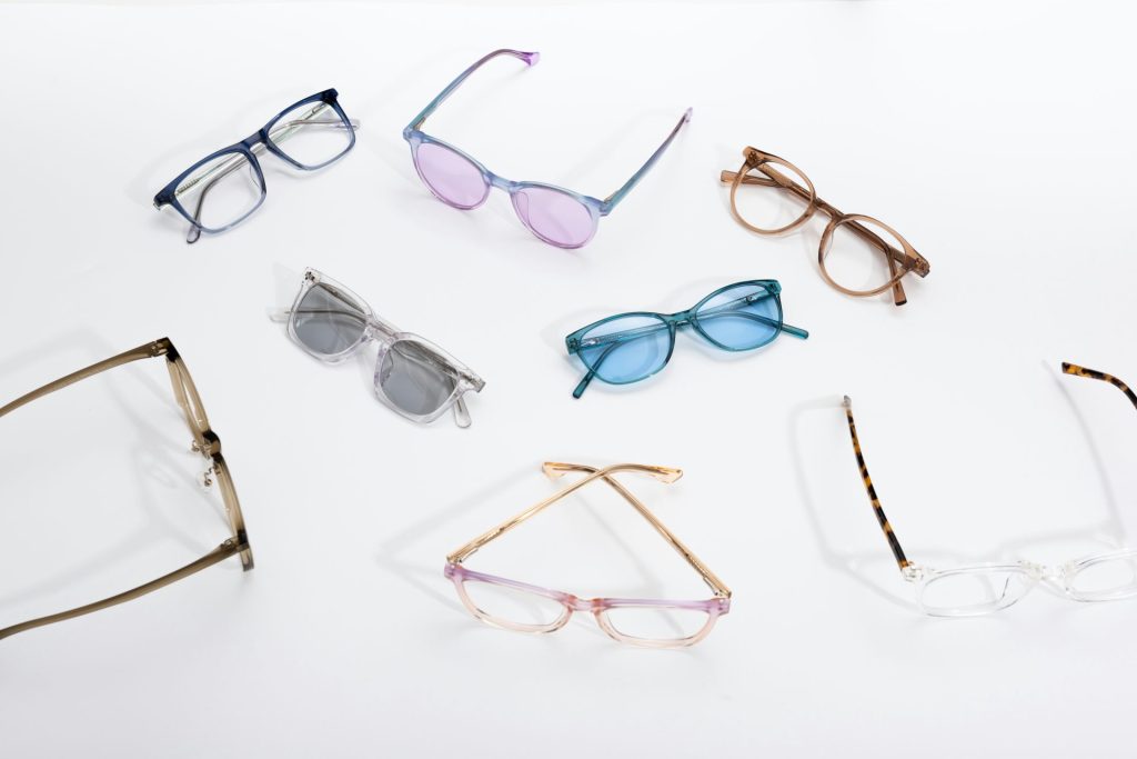 six pairs of glasses sitting on top of a white surface